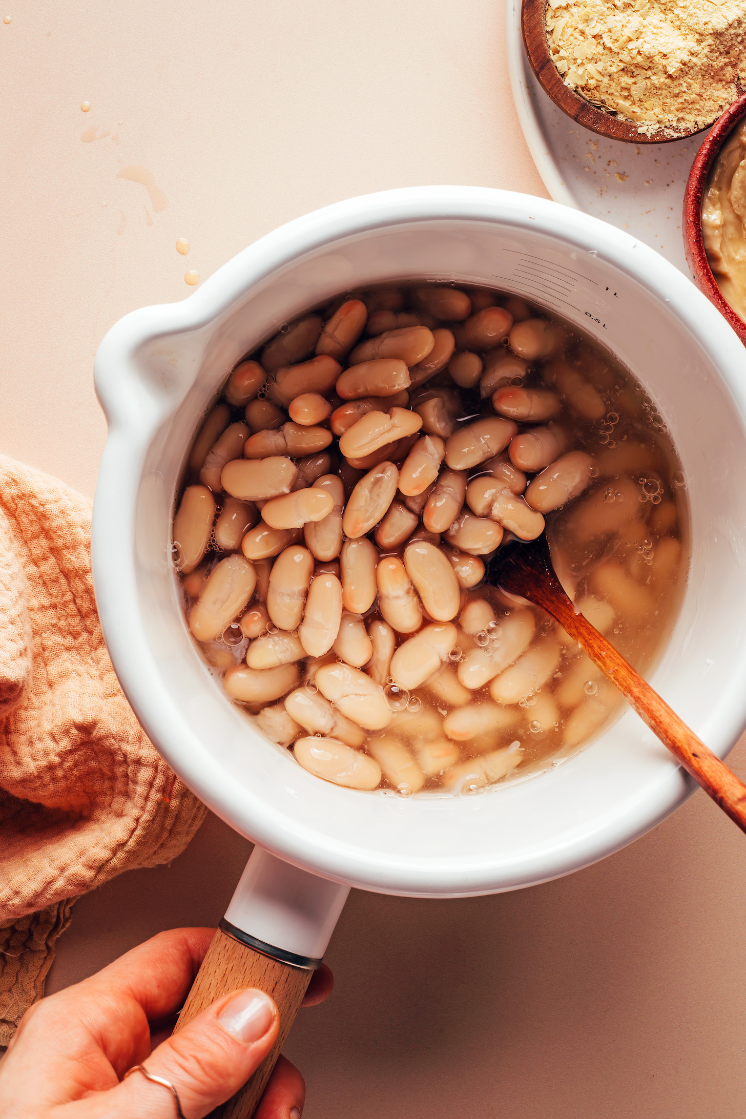 Heat the white beans in a saucepan