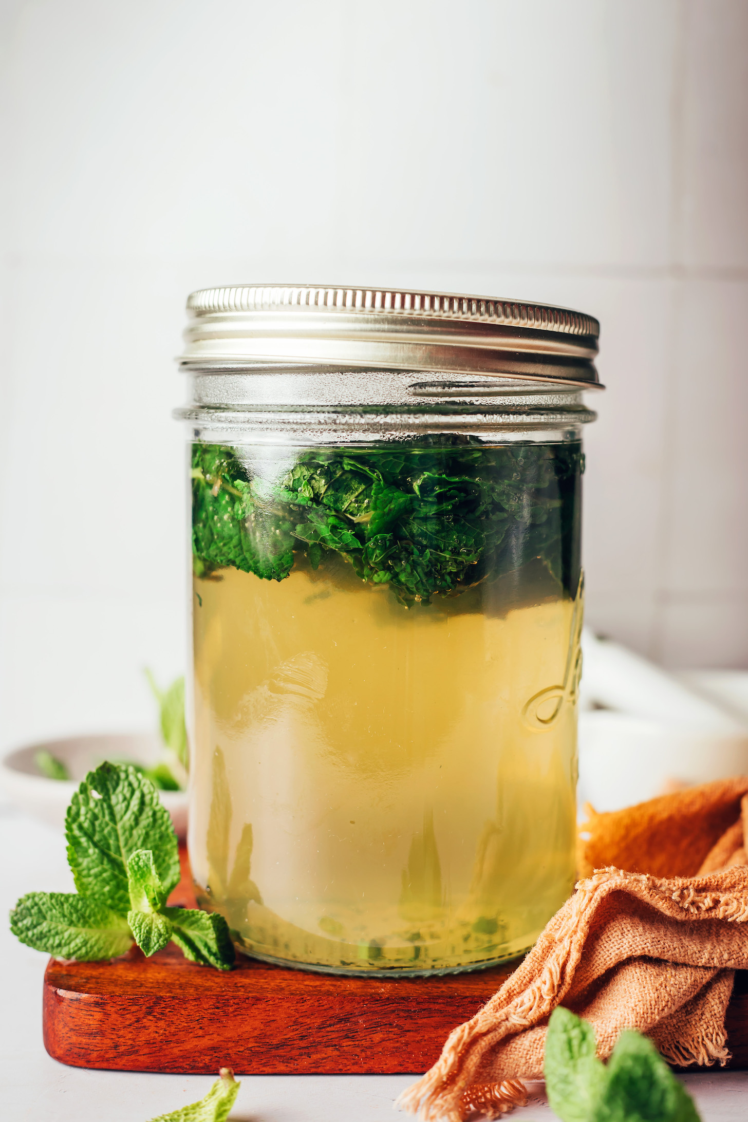 Jar of hot water and muddled mint leaves