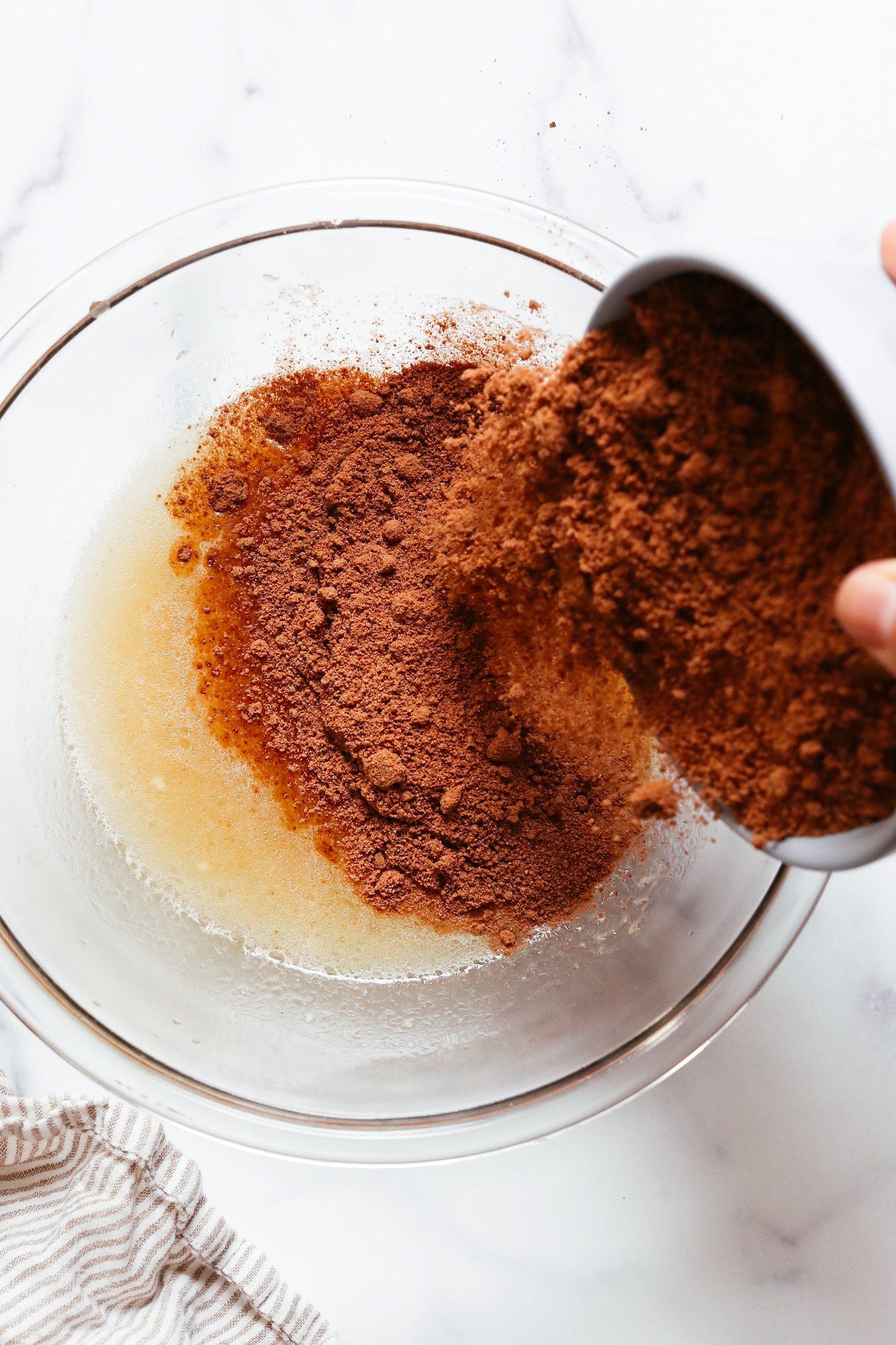 Pouring chocolate cake mix into the wet ingredients