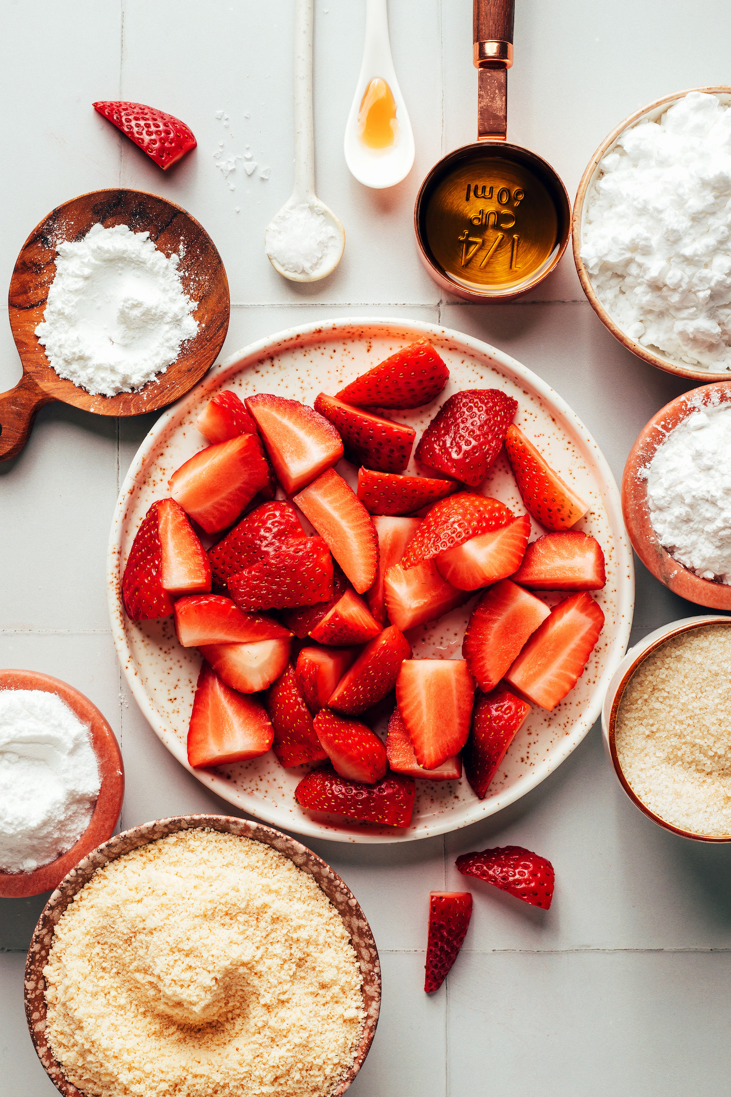 Almond flour, baking powder, strawberries, powdered sugar, salt, vanilla, maple syrup, arrowroot starch, potato starch, and cane sugar
