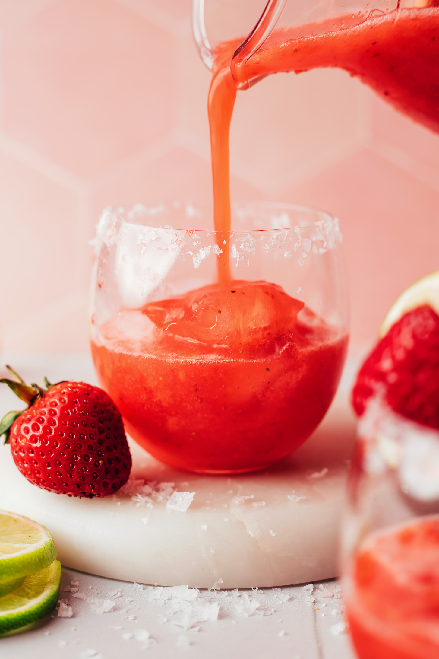 Pour a strawberry margarita over ice