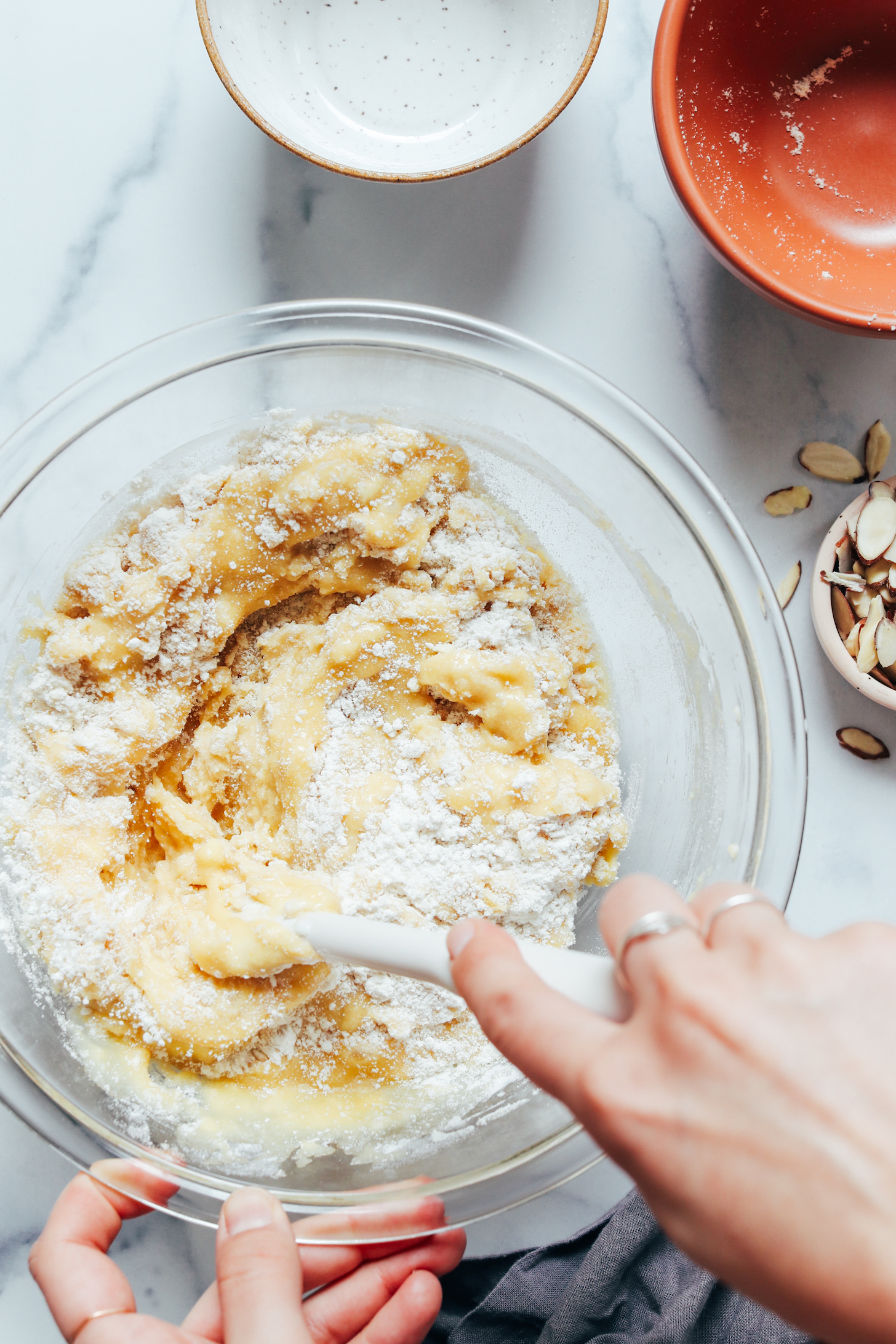 Mixing together the cake's wet and dry ingredients in a bowl