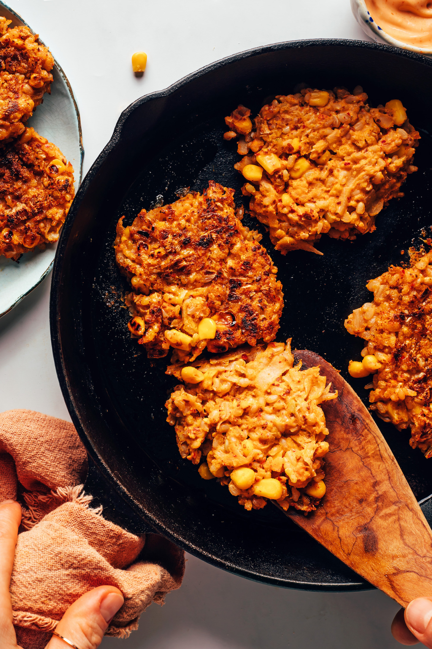 Cooking kimchi rice fritters in a cast iron skillet