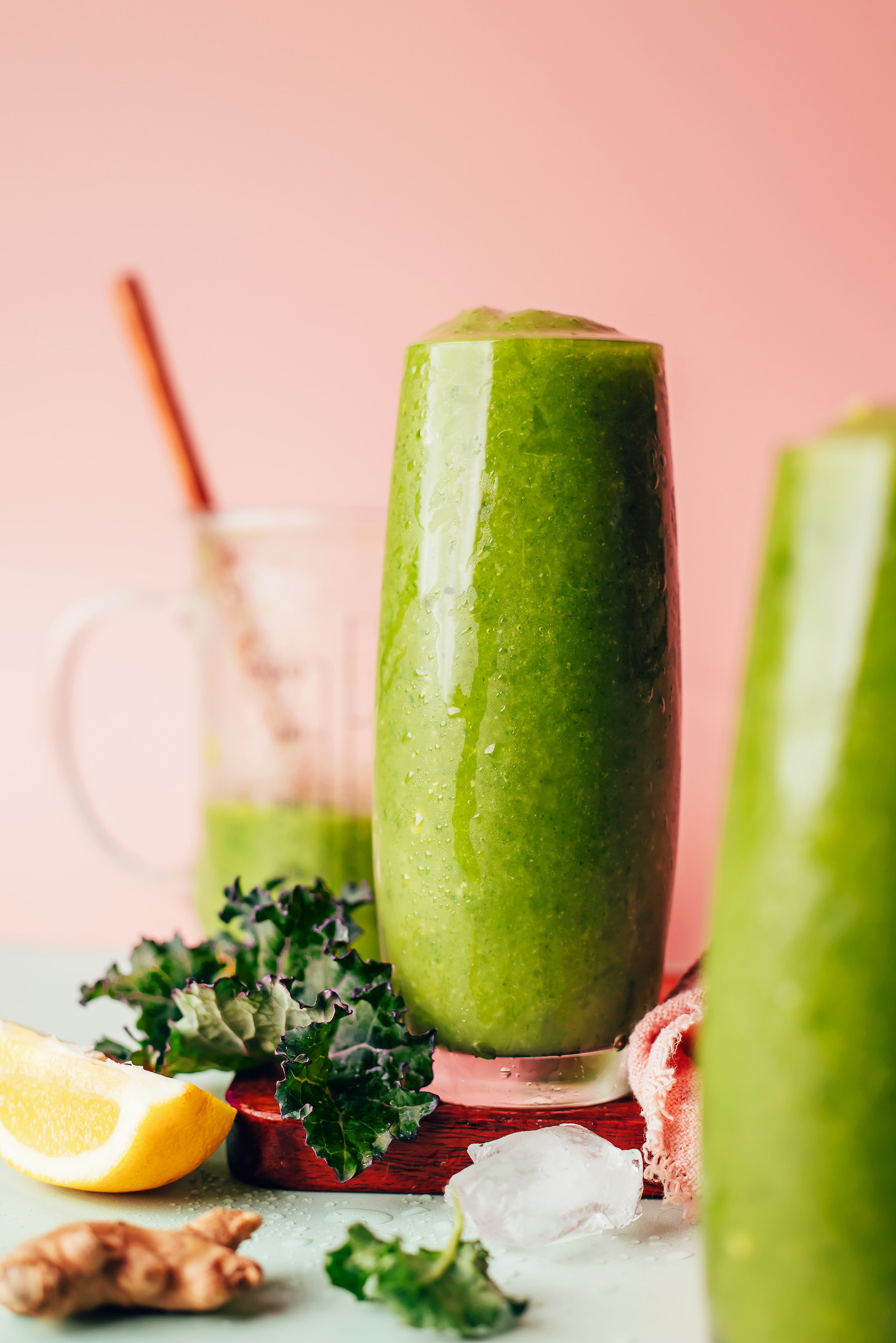 Tall drinking glasses filled with our Mango Ginger Kale Green Smoothie recipe