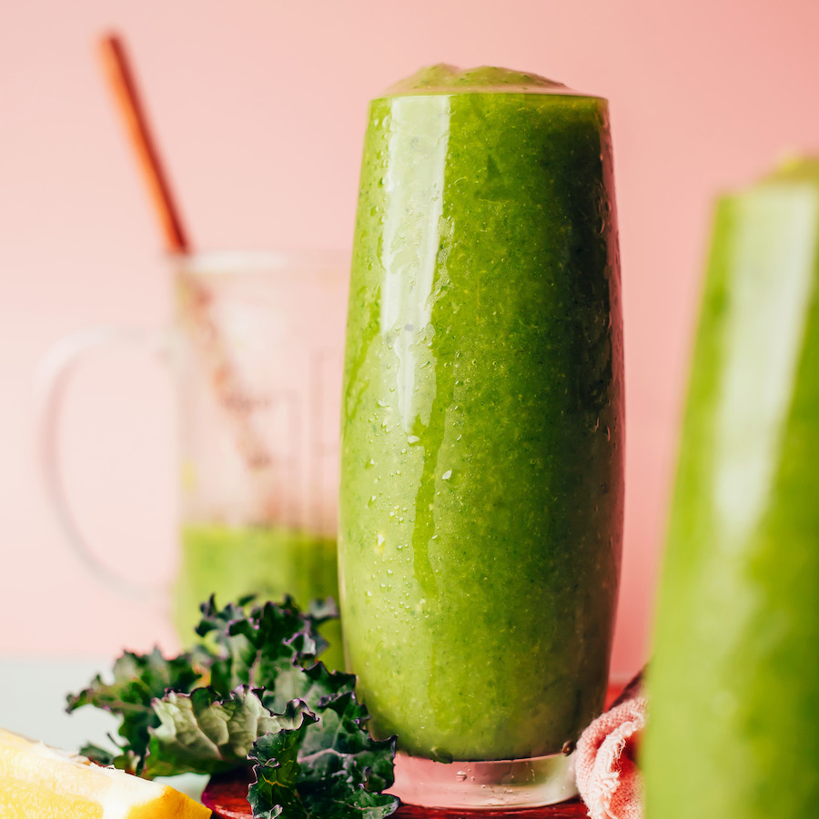Tall drinking glasses of our mango ginger kale green smoothie