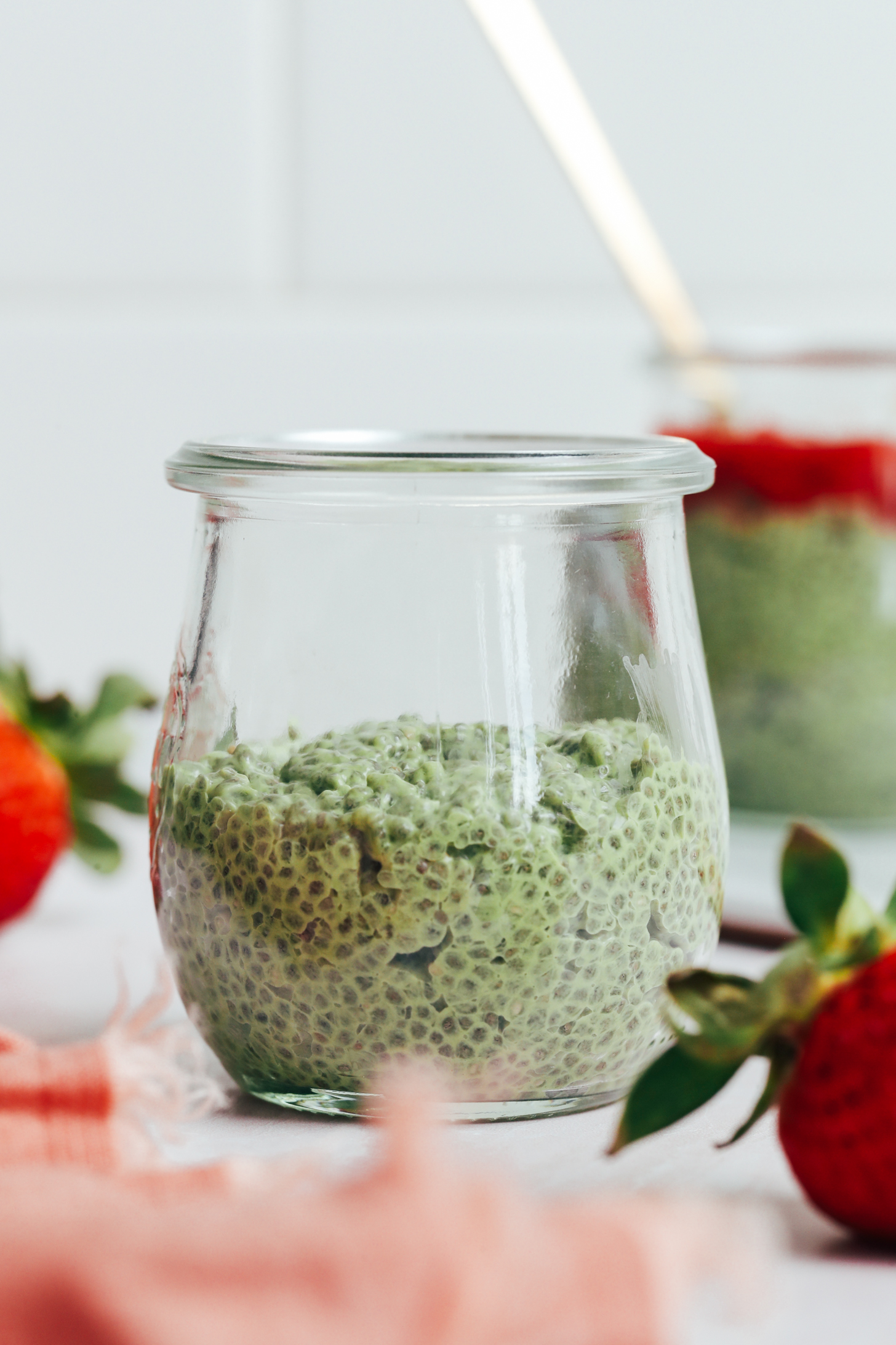 Small glass jar filled halfway full with matcha chia pudding