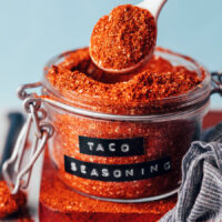 Holding a spoonful of DIY taco seasoning above a jar
