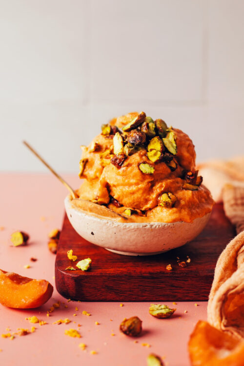 Bowl with scoops of apricot sorbet topped with candied pistachios