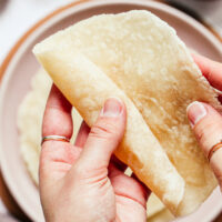 Rolling up a gluten-free flour tortilla