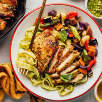 Bowl with pesto pasta, pesto chicken, and roasted vegetables