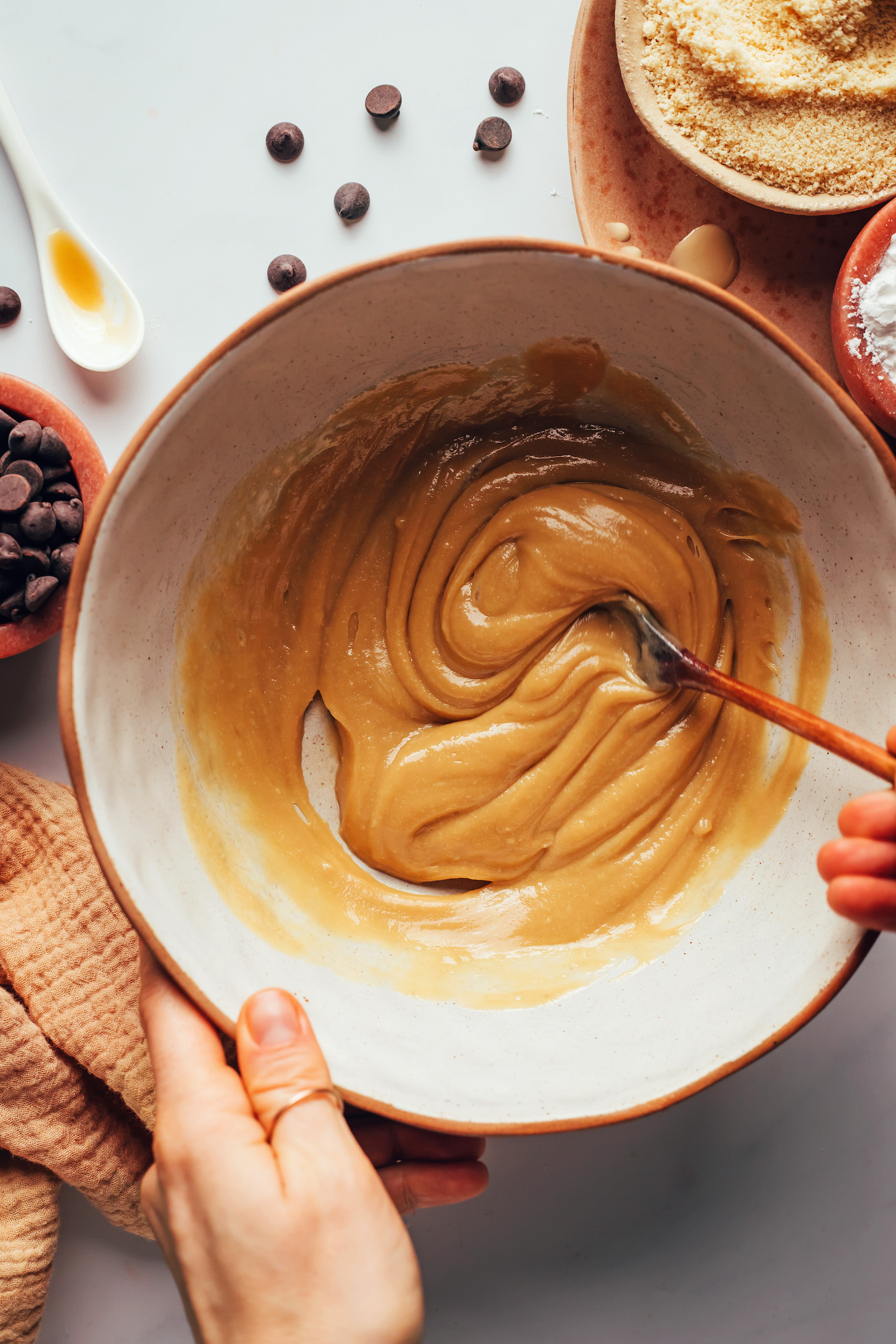 Stirring tahini, maple syrup, and vanilla in a bowl