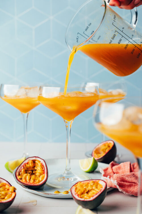 Pouring our spicy passion fruit mocktail into a glass