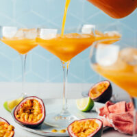 Pouring our spicy passion fruit mocktail into a drinking glass