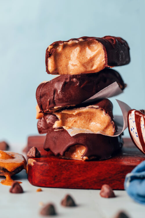 Stack of creamy vegan peanut butter ice cream bars with a chocolate coating