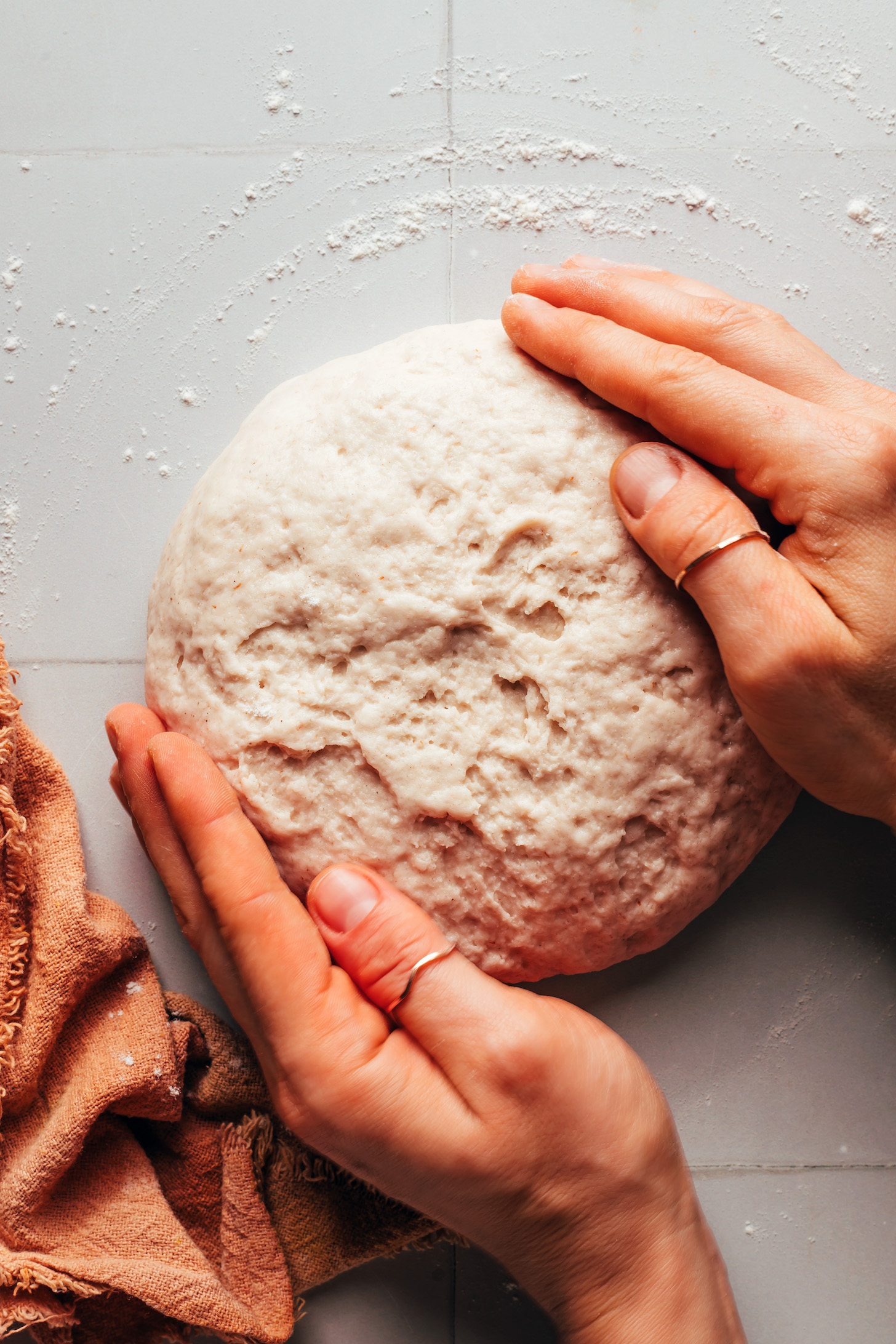 Holding the sides of shaped dough