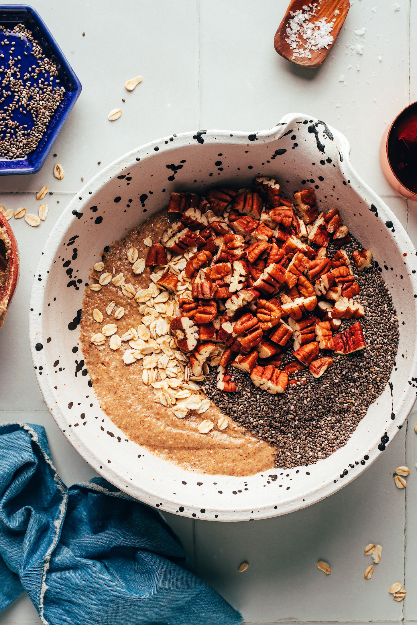 Pecans, chia seeds, and oats in a bowl of cookie batter