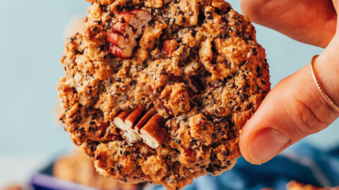 Holding a chai-spiced granola cookie with the top facing the camera