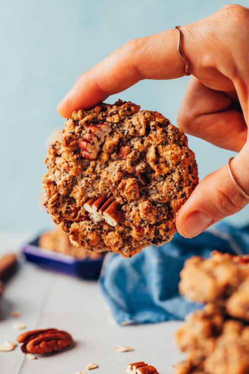 Holding a chai-spiced granola cookie with the top facing the camera