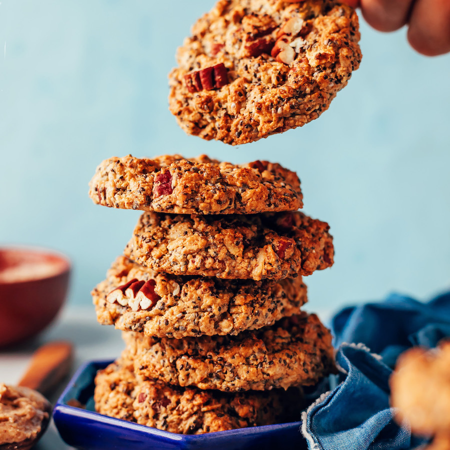 Picking up a flourless chai-spiced cookie from a stack of more cookies