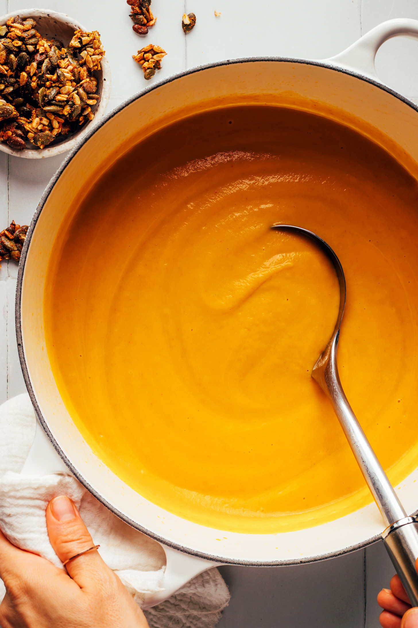 Ladle in a pot of creamy vegan carrot ginger soup