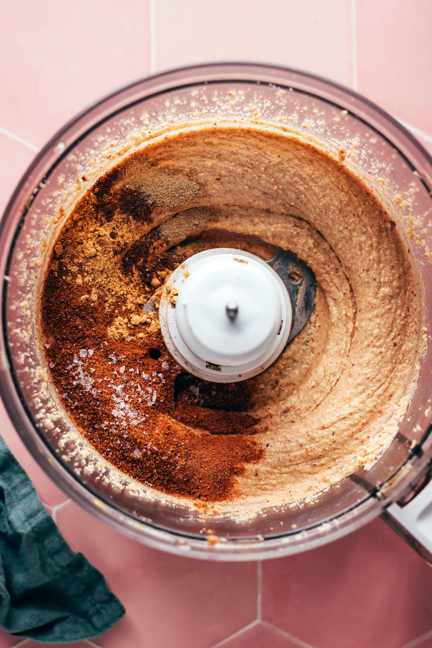 Coconut sugar, salt, and spices in a food processor of homemade nut butter