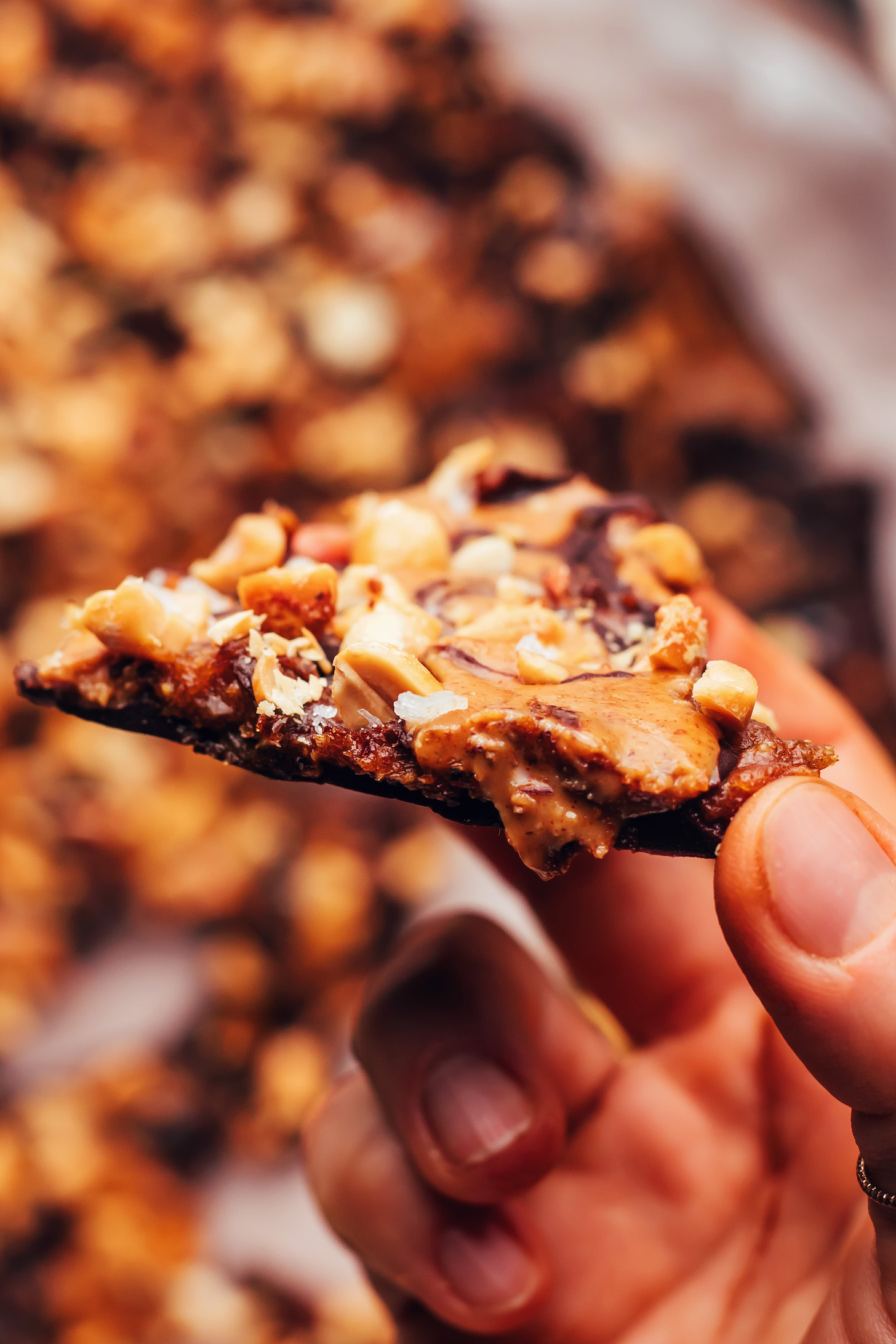 Holding a piece of Snickers chocolate bark