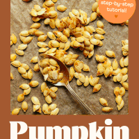 Homemade roasted pumpkin seeds on a parchment-lined baking sheet