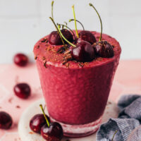 Glass of our chocolate cherry protein shake topped with cherries