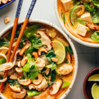 Chopsticks in a bowl of our cozy Thai-inspired curry noodle soup