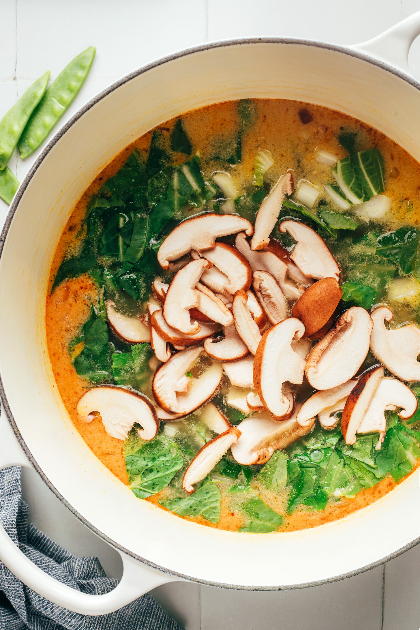 Sliced mushrooms and bok choy over a curry broth