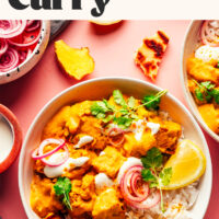 Korma-inspired vegan tofu cauliflower curry written above a bowl of curry with rice