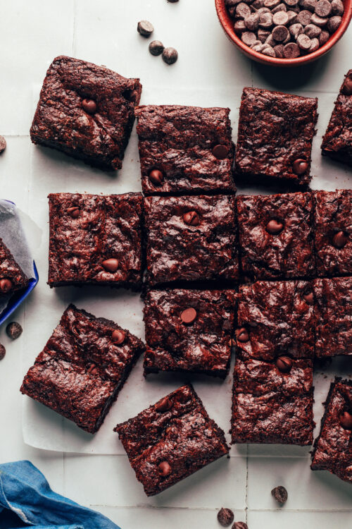 Overhead shot of our fudgy crackly top vegan gluten-free brownies on a piece of parchment paper