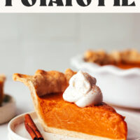 Slice of vegan gluten-free sweet potato pie on a plate topped with coconut whipped cream