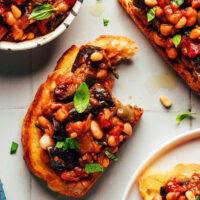 Slices of toasted bread topped with white bean eggplant caponata