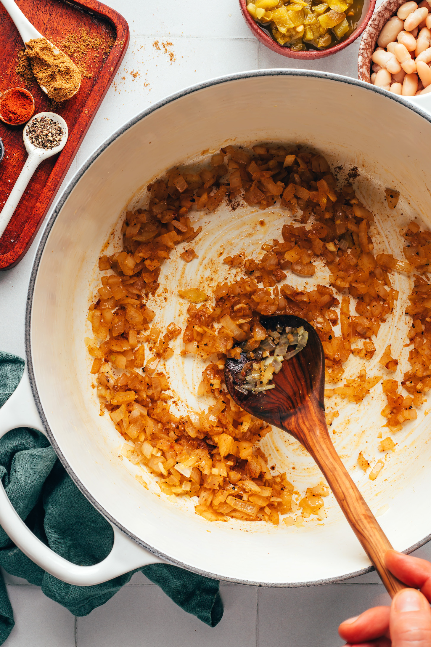 Sautéed onion, garlic, cumin, cayenne, salt, and pepper in a pot