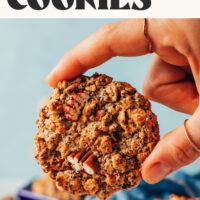 Holding a flourless chai-spiced oatmeal cookie with the top facing the camera