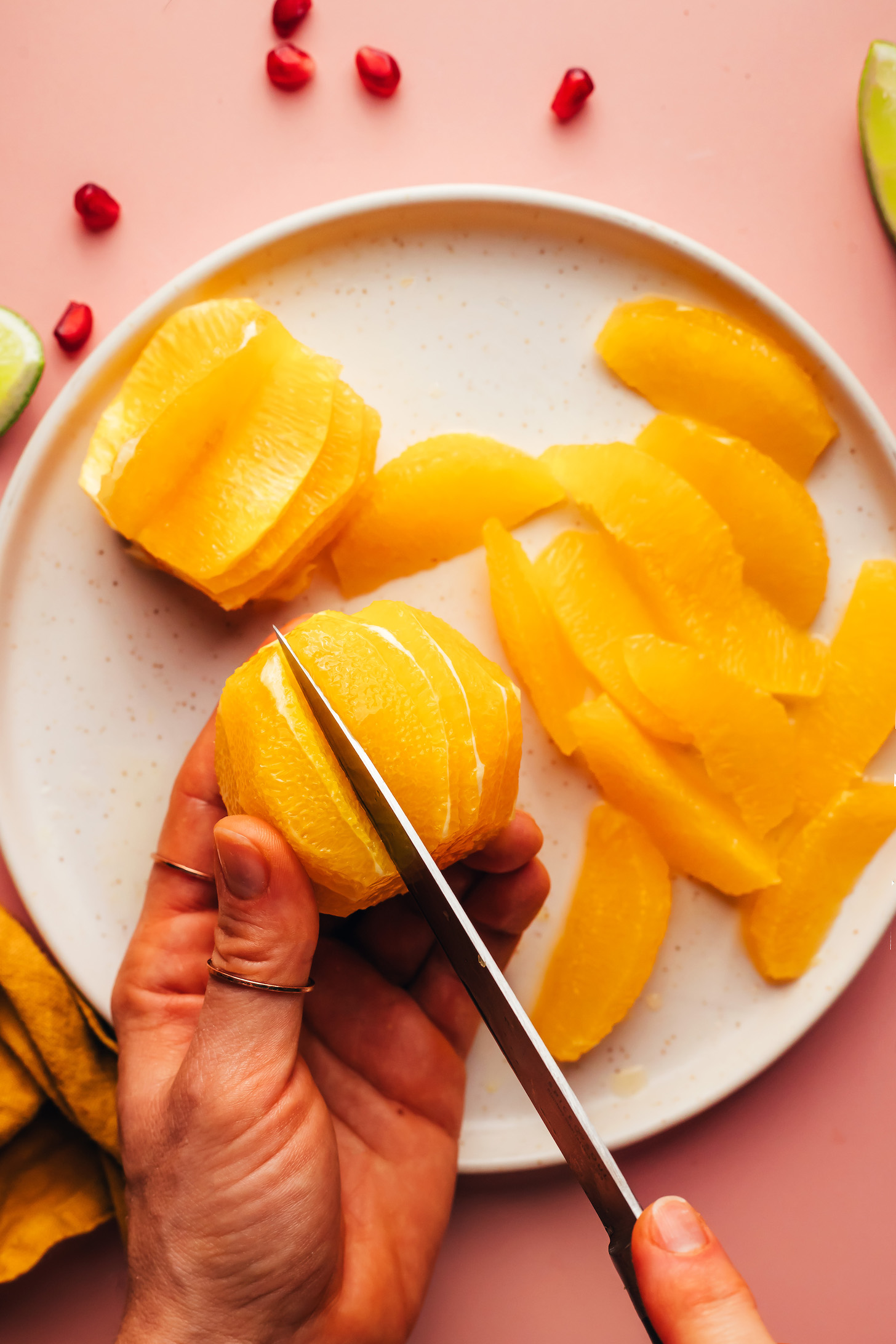 Slicing into a peeled orange to show how to segment it