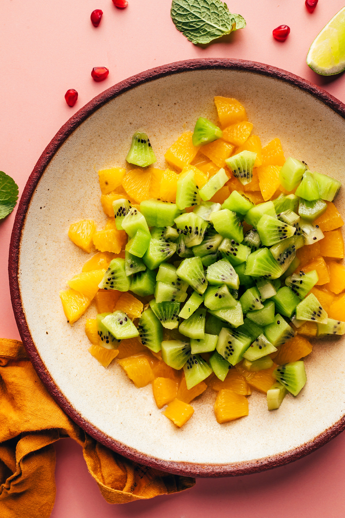 Bite-sized pieces of orange and kiwi in a bowl