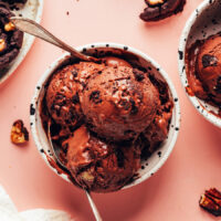 Overhead shot of scoops of vegan chocolate brownie ice cream in a bowl