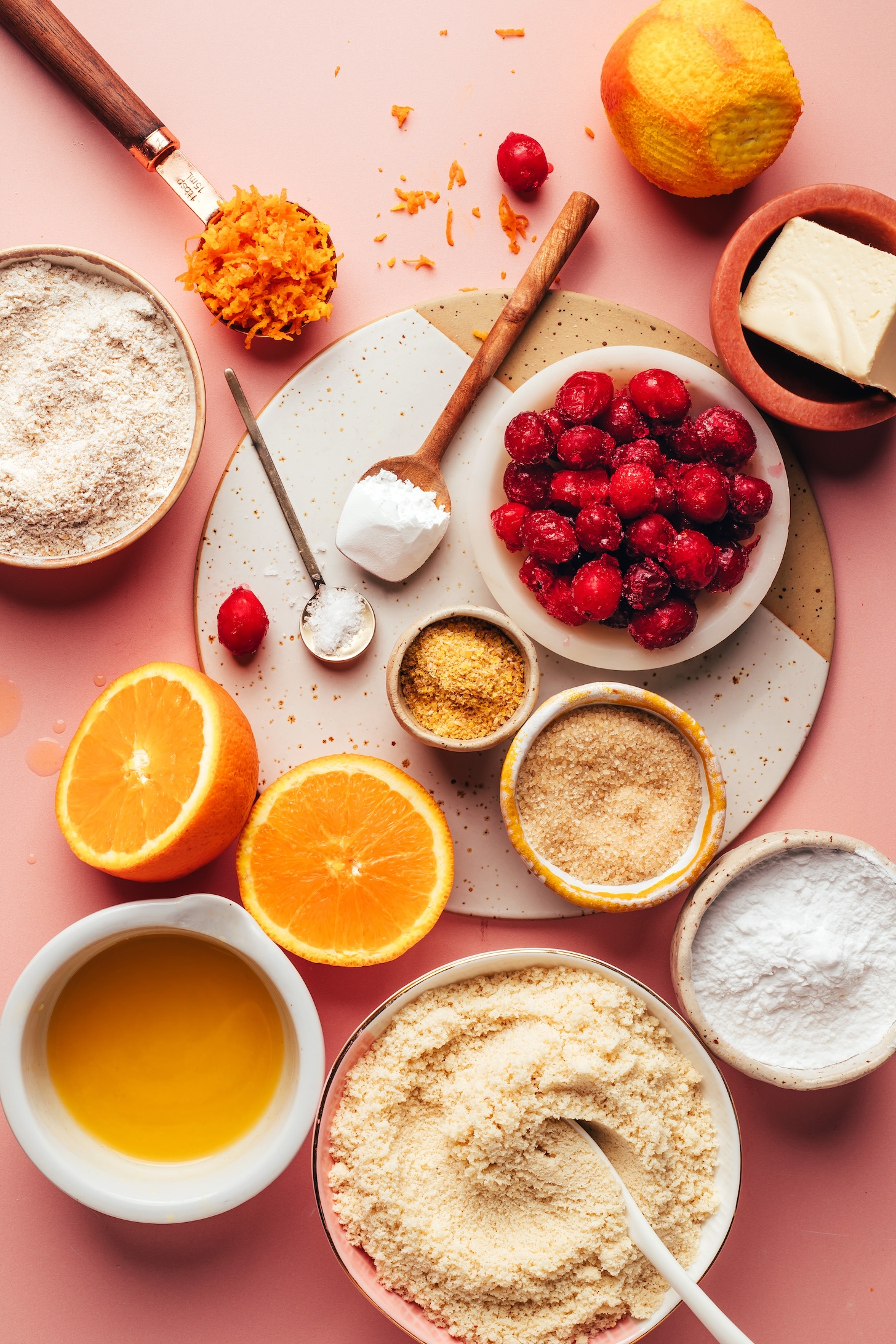 Vegan butter, frozen cranberries, orange zest, oat flour, baking powder, salt, flaxseed meal, cane sugar, potato starch, almond flour, and orange juice