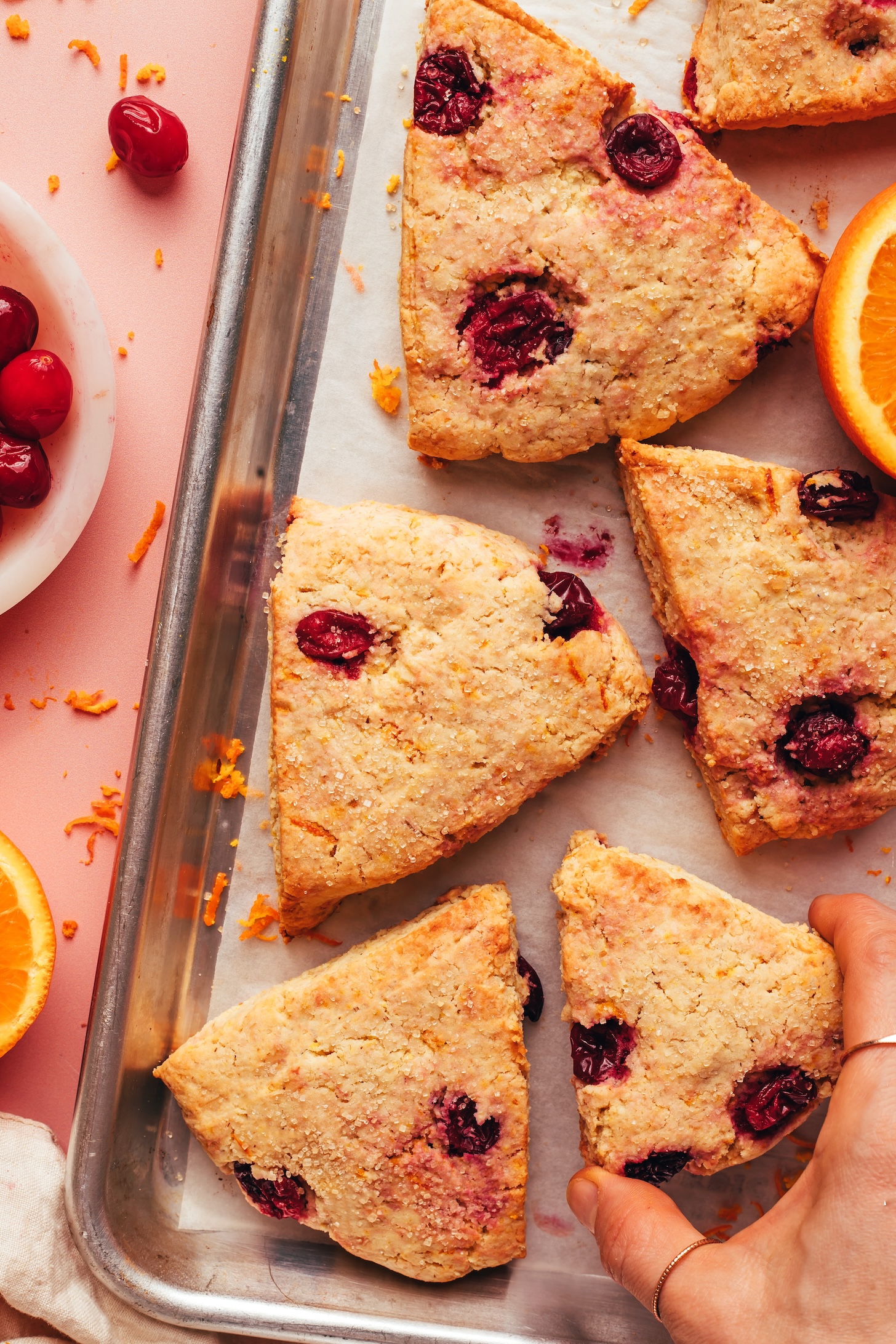 Baking sheet of freshly baked vegan gluten-free cranberry orange scones