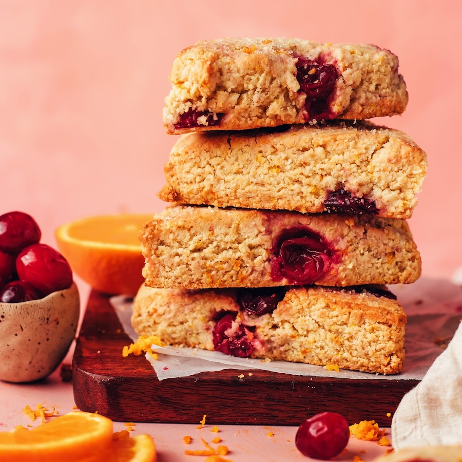 Close up photo of a stack of vegan gluten-free cranberry orange scones