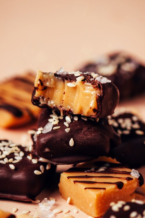 Stack of vegan sea salt caramels with some coated and some drizzled with dark chocolate