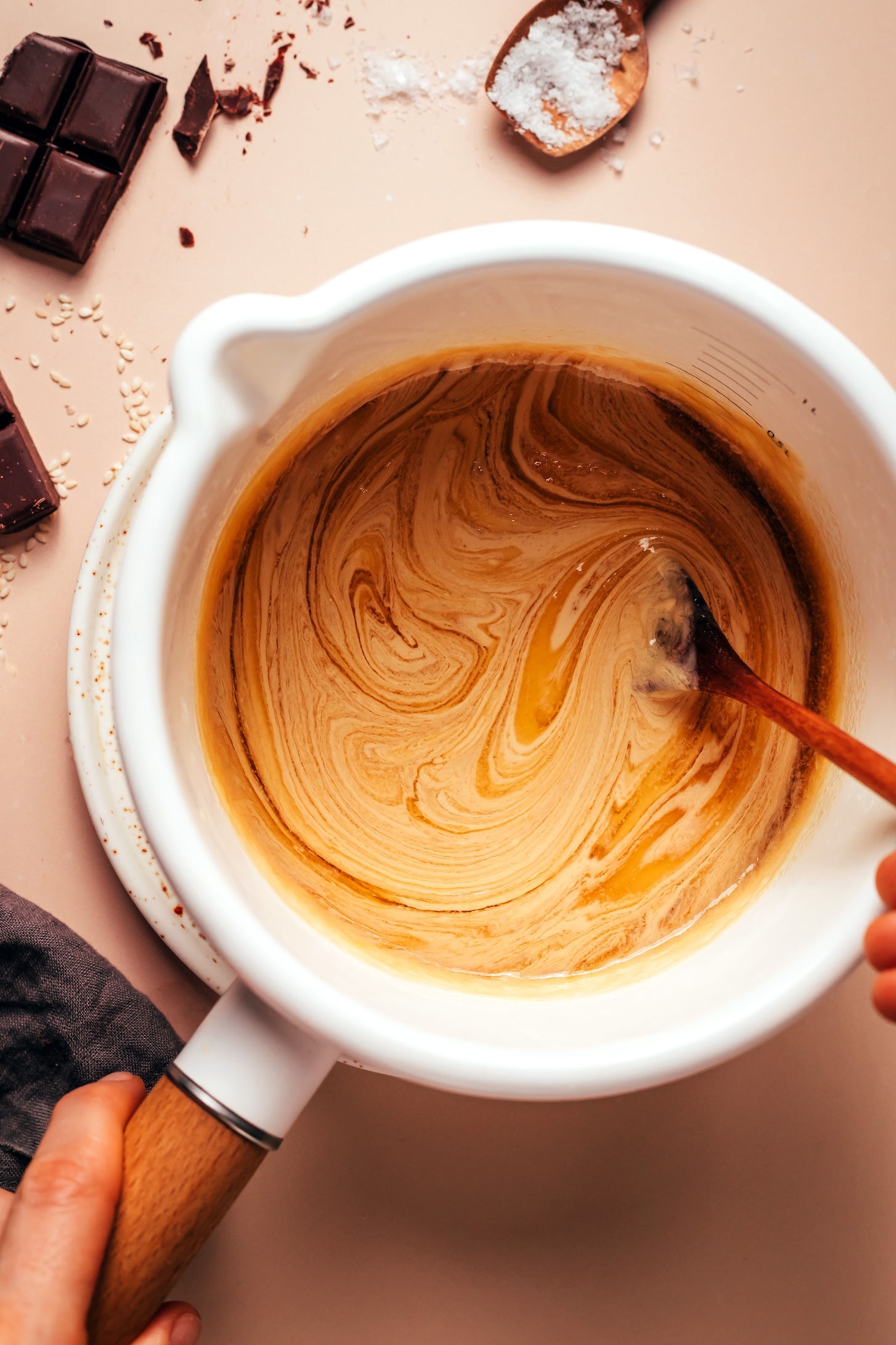 Swirling tahini into a naturally sweetened vegan caramel mixture