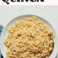 A bowl of perfectly cooked quinoa with text above it saying Fluffy Instant Pot Quinoa