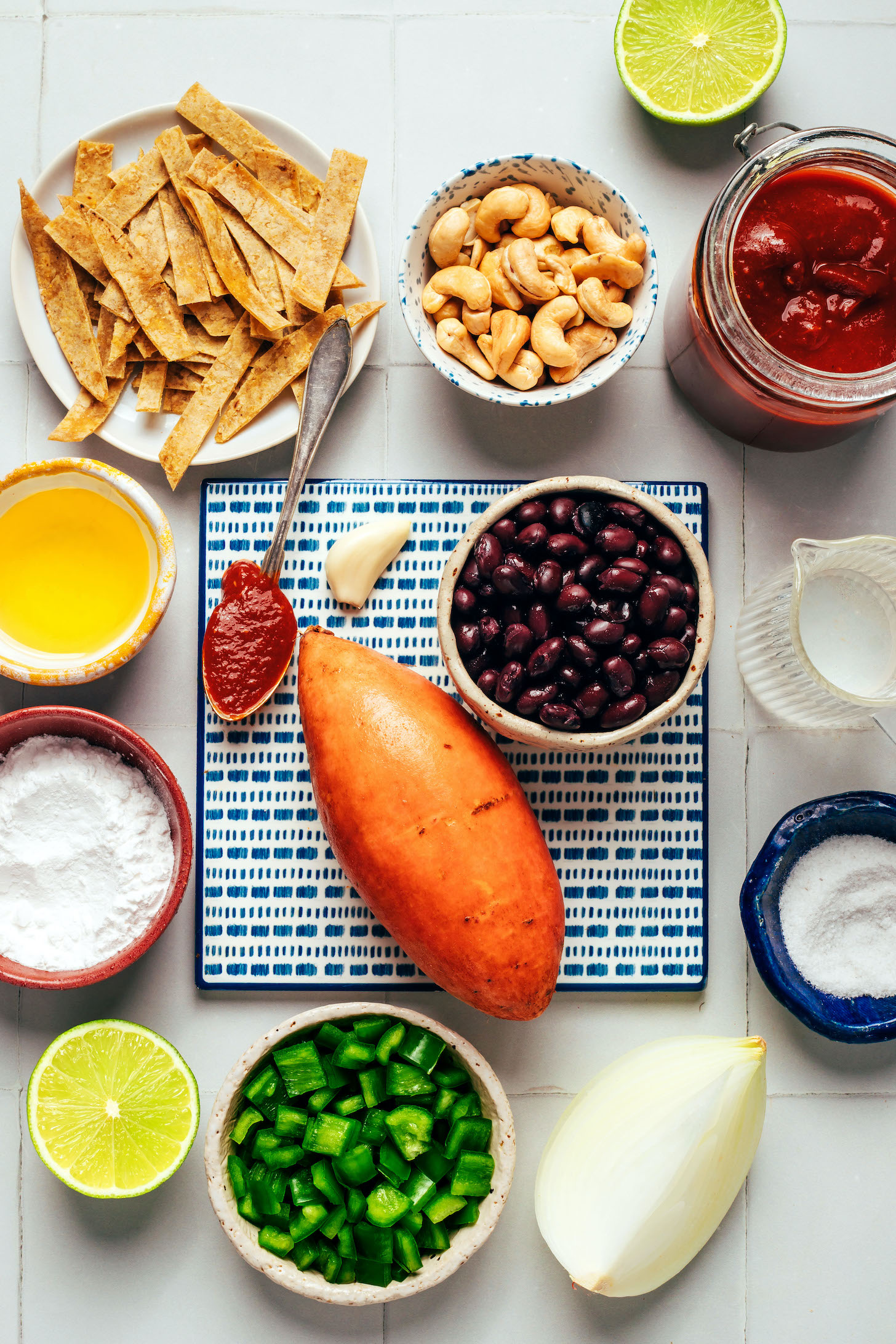 Corn tortillas, cashews, enchilada sauce, water, salt, black beans, sweet potato, garlic, onion, poblano pepper, lime, tapioca starch, and oil