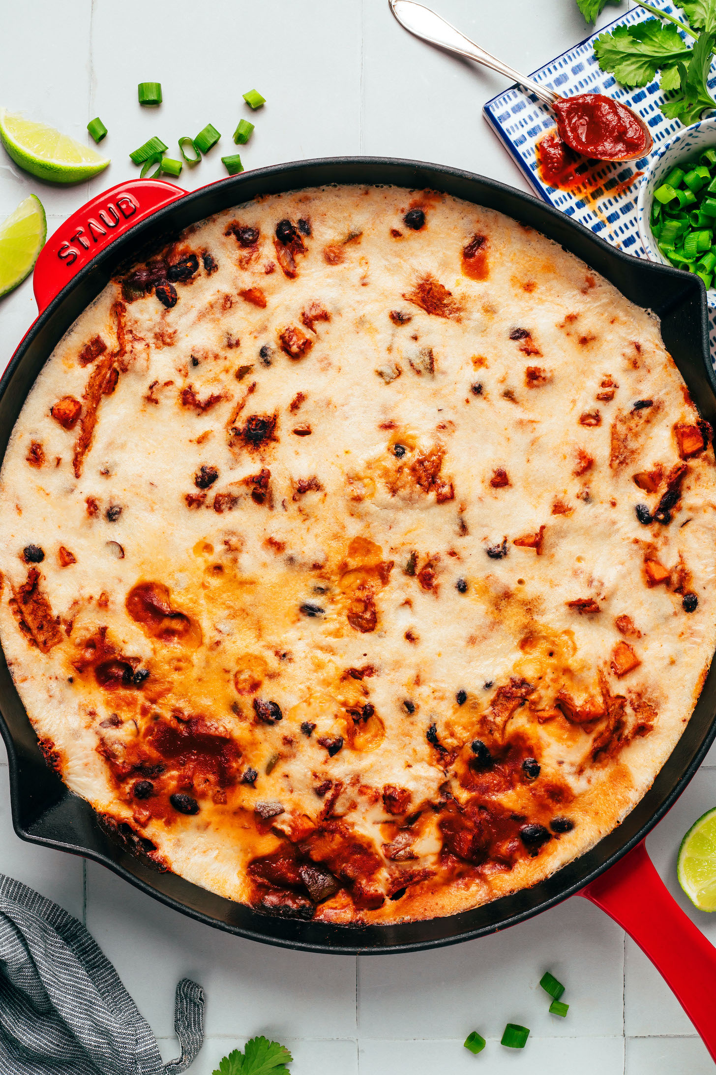 Overhead photo showing the cashew cheese layer of our cheesy vegan enchilada skillet recipe