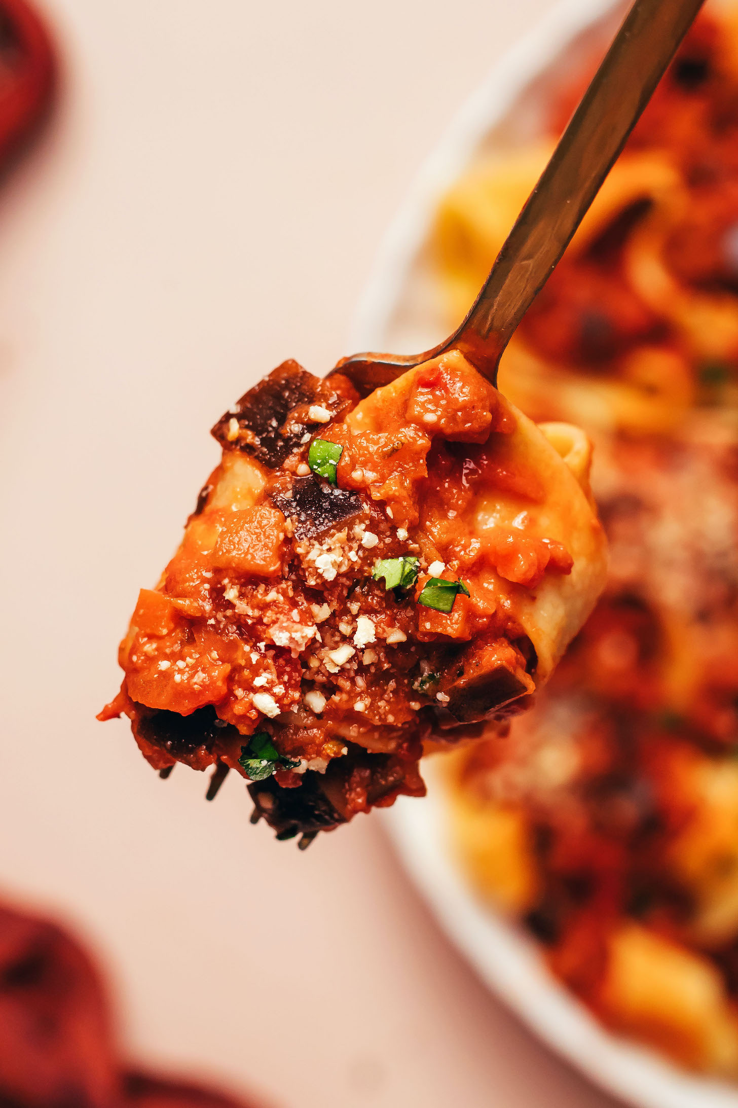 A bite of eggplant bolognese on a fork
