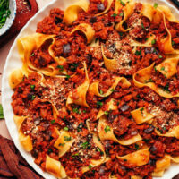 Close up photo of a plate of our eggplant bolognese served with pappardelle