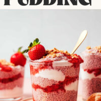 Jars of strawberry chia pudding with layers of strawberry compote, coconut yogurt, and crushed graham crackers